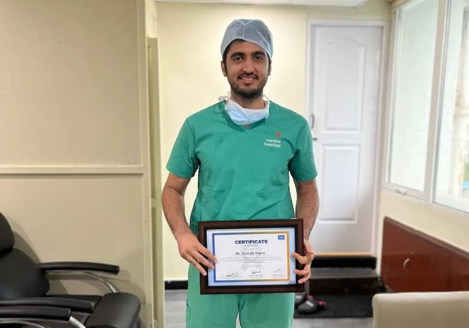 Dr. Dipen Ariwala holding his completed fellowship certificate